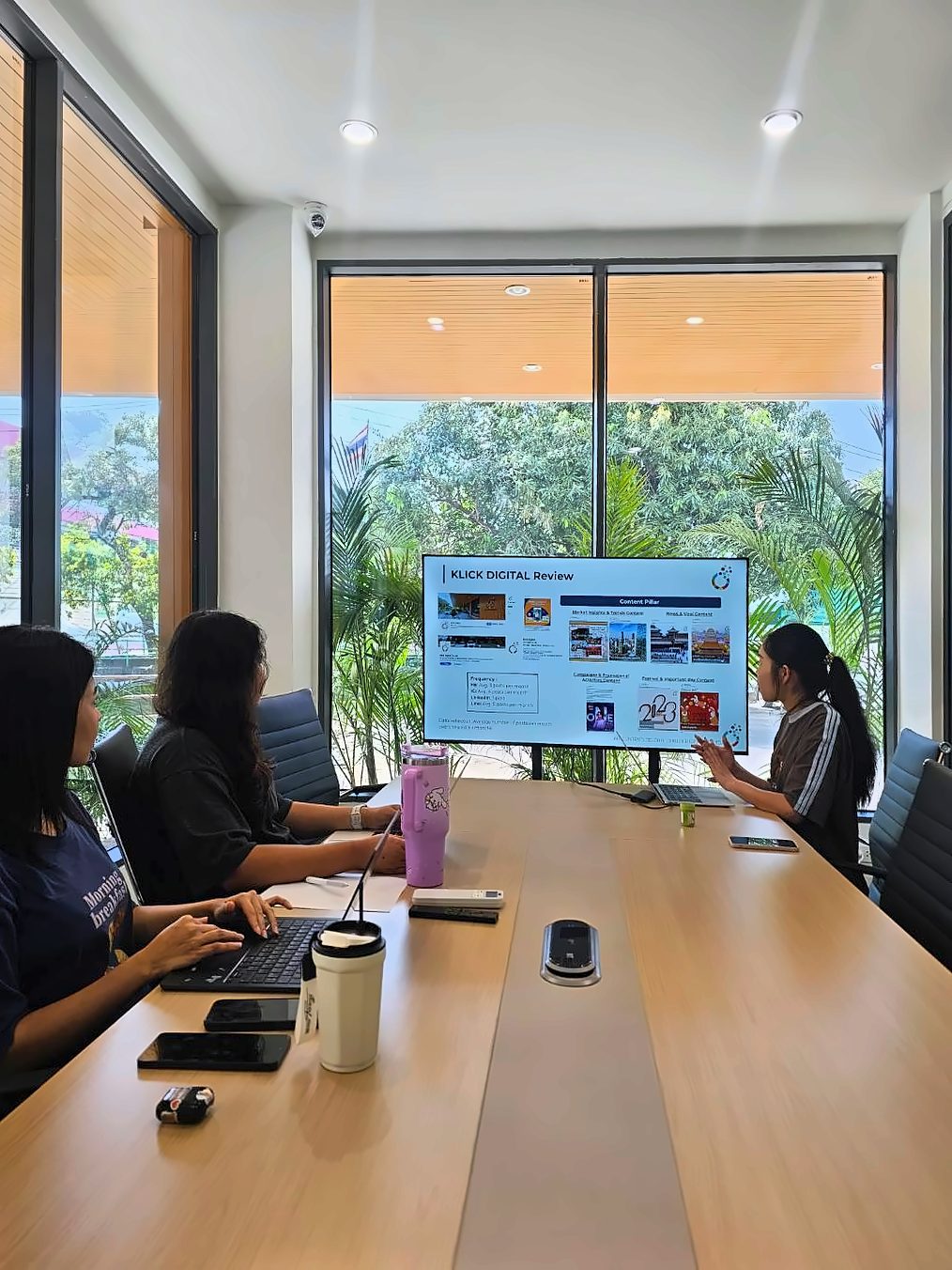 Klick Digital team reviewing a content presentation on the screen in the Bangkok office meeting room